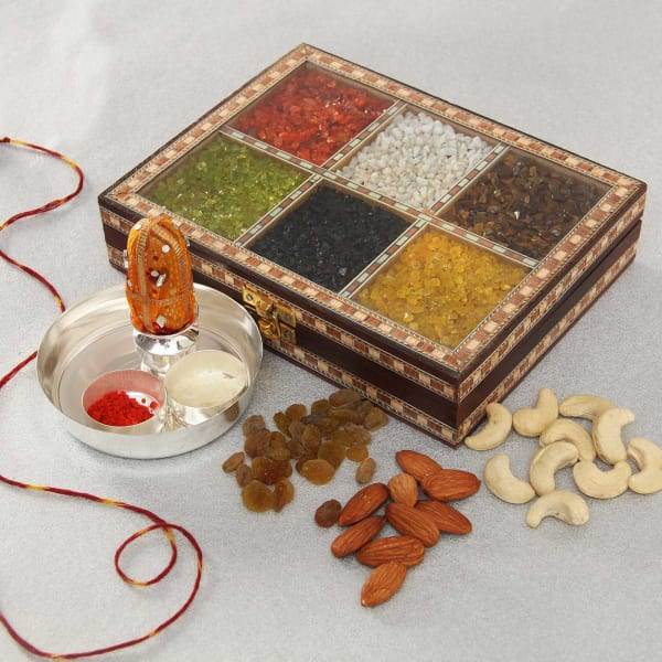 assorted dry fruits with silver plated puja thali in handmade colorful stone