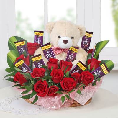 basket of roses with chocolate teddy